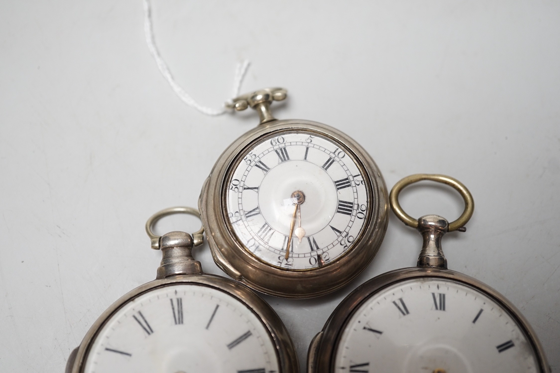 An 18th century silver pair cased keywind verge pocket watch, by Sam Toulmin, London, a similar watch by Tomlin, London and one other silver pair cased pocket watch with unsigned movement.